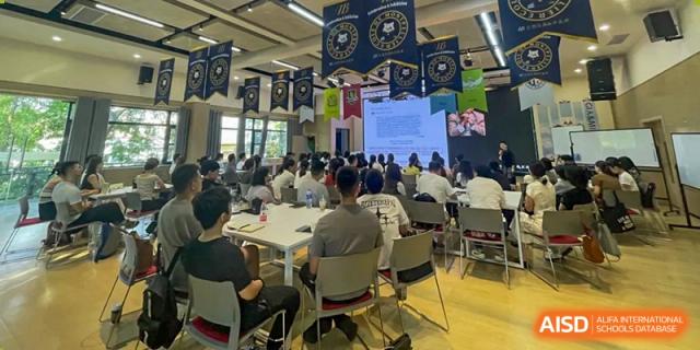 A male guest speaker gives an enthusiastic presentation to a classroom of students during a specialized academic seminar at Griffin International Academy.