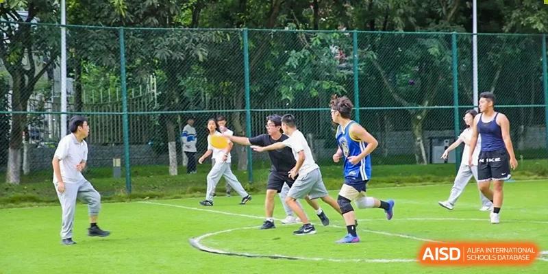 Students participate in a fast-paced game of flag football or tag on an outdoor green field at Griffin International Academy.