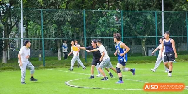Students participate in a fast-paced game of flag football or tag on an outdoor green field at Griffin International Academy.