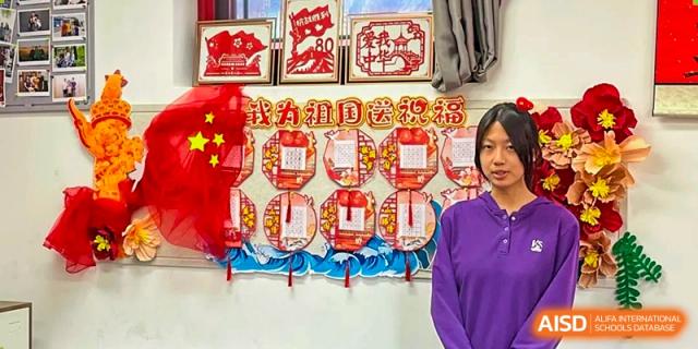Traditional Chinese paper-cutting art is displayed on a colorful bulletin board in a hallway at Beijing No. 35 High School International Department.
