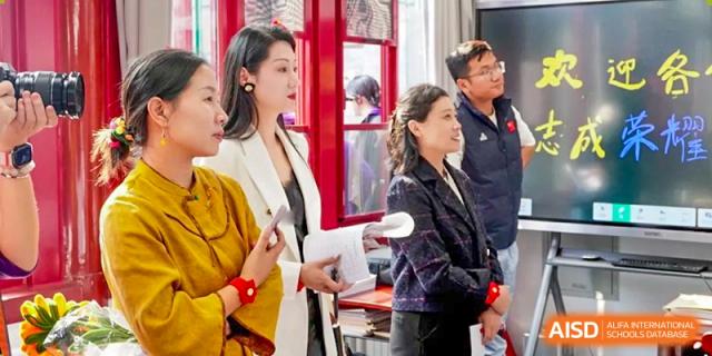 Faculty members in professional attire participate in a guided tour of the historic campus at Beijing No. 35 High School International Department.