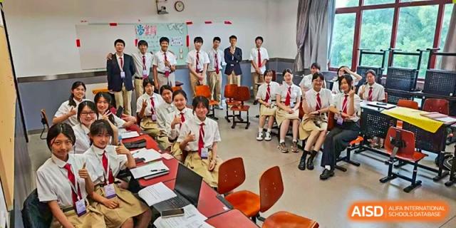 Students sit in a large circle on the classroom floor for a collaborative group discussion at Beijing No. 35 High School International Department.