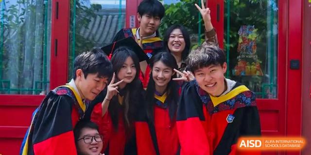 A group of students in red and black hoodies poses together for a friendly group photo at Beijing No. 35 High School International Department.