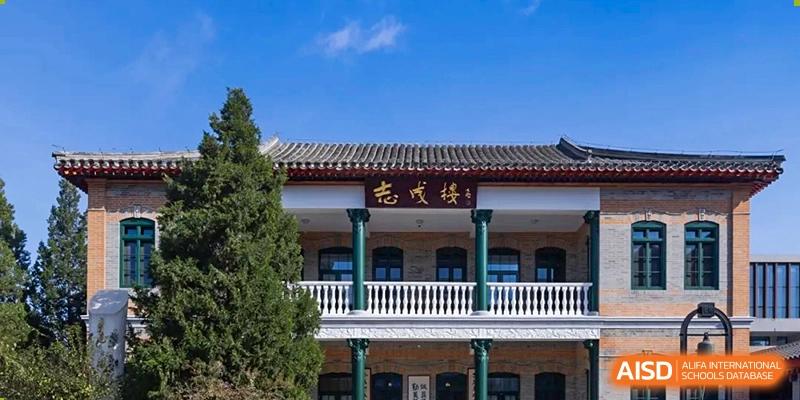 The elegant facade of a campus building features traditional Chinese design elements and green pillars at Beijing No. 35 High School International Department.