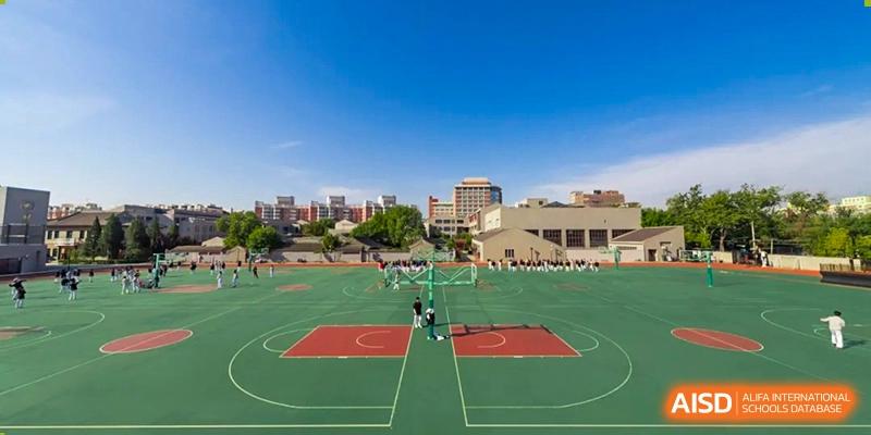 An expansive outdoor basketball complex sits under a clear blue sky on the campus of Beijing No. 35 High School International Department.
