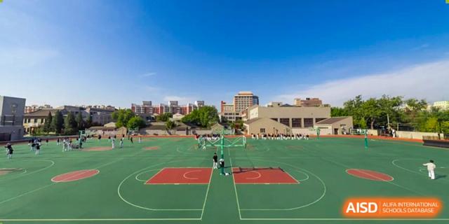 An expansive outdoor basketball complex sits under a clear blue sky on the campus of Beijing No. 35 High School International Department.