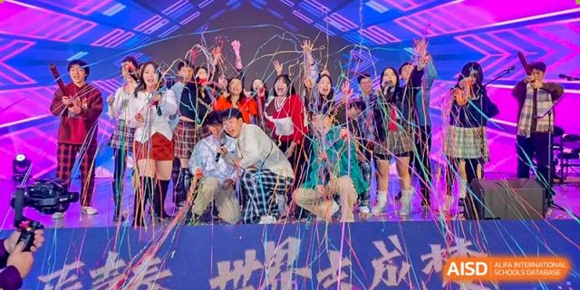 Students celebrate on stage amid a shower of colorful confetti during a school festival at Beijing No. 35 High School International Department.
