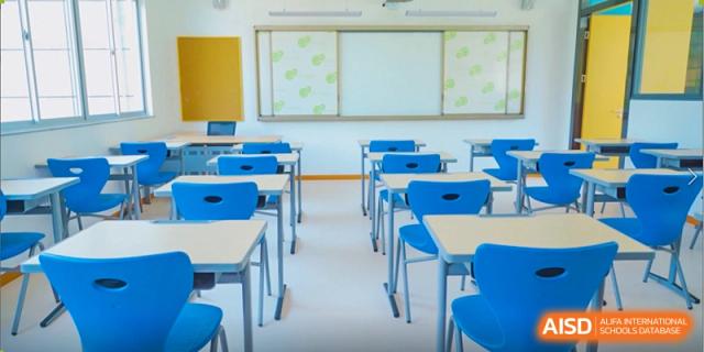 A clean and organized classroom with rows of blue desks and chairs prepared for daily learning at Xiamen ITG-SUIS High School
