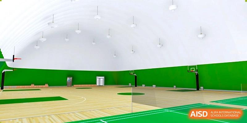 Indoor school sports hall with green walls and a marked basketball court, providing a clean and spacious environment for physical education, training, and student activities at Xiamen ITG-SUIS High School