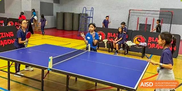 Students practice their table tennis skills during an indoor physical education class at TEDA International School Tianjin.