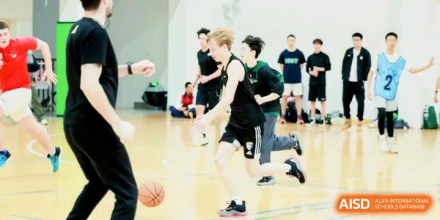 Students play a competitive basketball game in the indoor gym at Shanghai Gold Apple Bilingual School.