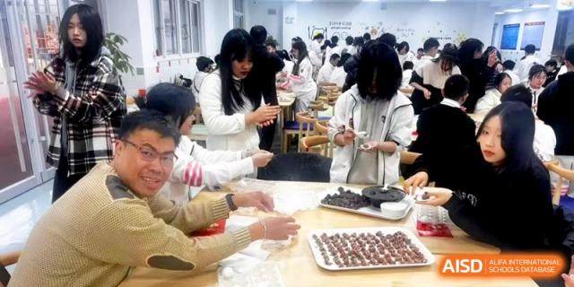 A teacher guides students through the process of making traditional Chinese snacks at Shanghai Gold Apple Bilingual School.