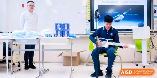 A student plays a futuristic white string instrument during a performance or music class at Shanghai Qingpu World Foreign Language High School.