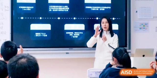 A teacher uses hand gestures while presenting a digital timeline on a large interactive screen at Shanghai Qingpu World Foreign Language High School.