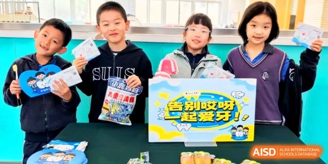 Two students smile while presenting their project about dental health and hygiene. | Shanghai United International School, Hongqiao Campus