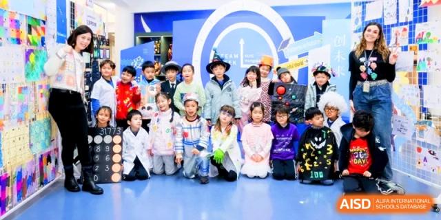 A large group of students in costumes poses together for a group photo in the school hall. | Shanghai United International School, Hongqiao Campus