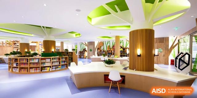 An ultra-modern school library and study area featuring stylish white desks and creative green ceiling accents for students at Shanghai United International School, Hongqiao Campus