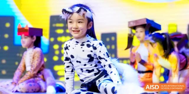 A young student dressed in a dalmatian costume with cat ears performs during a creative arts and cultural event at Shanghai United International School, Hongqiao Campus