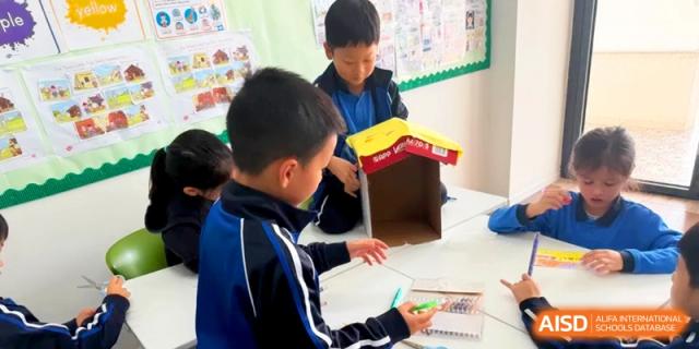 A student focuses on building a cardboard structure during a creative design and technology class at Shanghai United International School, Pudong