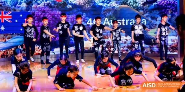 Students performing a creative modern dance routine in themed black outfits at Shanghai United International School, Shangyin Campus.
