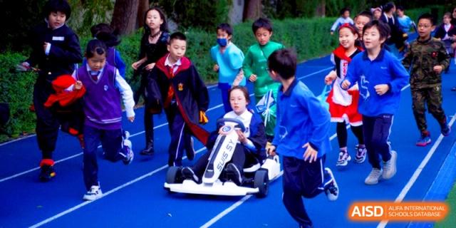Students racing a student-built go-kart on the school's outdoor track at Shanghai United International School, Shangyin Campus.