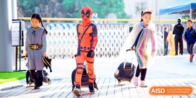 A student dressed in a full Deadpool superhero costume walks through the hallway at Shanghai United International School, Shangyin Campus.