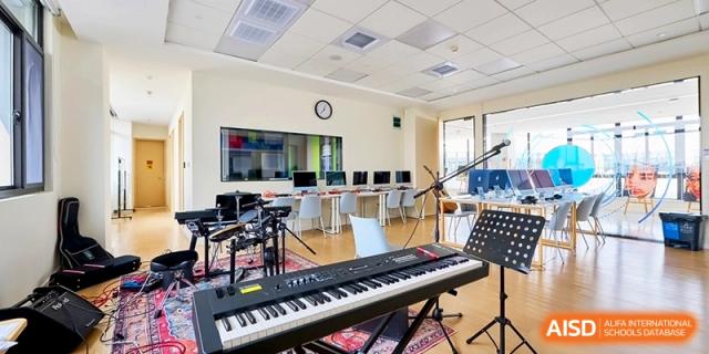 The music studio contains keyboards, drums, and recording equipment for students to explore their creativity at Shanghai United International School, Qingpu Campus