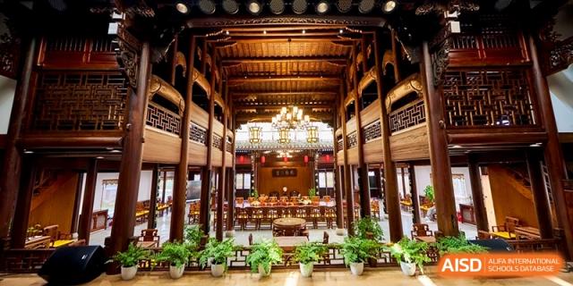 Traditional Chinese style hall with wooden beams and ornate decorations at Shanghai United International School,Qingpu Campus