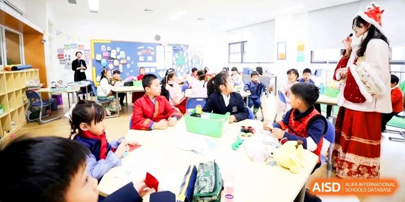 Students in school uniforms sitting around a table and participating in a collaborative group learning activity at HT Nanjing Impact Academy.