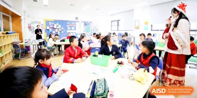 Students in school uniforms sitting around a table and participating in a collaborative group learning activity at HT Nanjing Impact Academy.