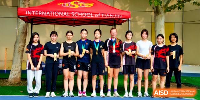 A row of student-athletes shows off their awards and medals after a successful competition at the International School of Tianjin.