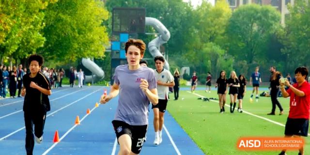 A student athlete stays focused while running a sprint during an outdoor track event at the International School of Tianjin.