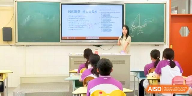 A teacher presents a lesson using a large interactive digital screen to a class of attentive students at Xishan Senior High School.