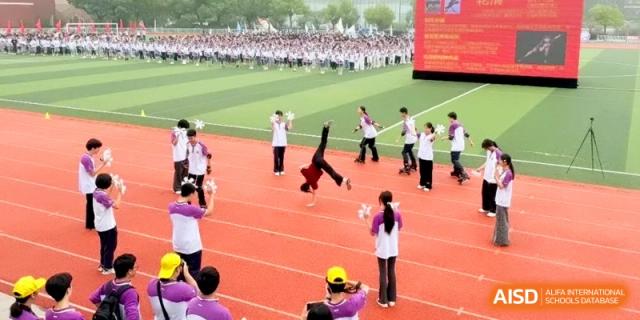 Students perform a synchronized dance and gymnastics routine on the red track during a sports meet at Xishan Senior High School.