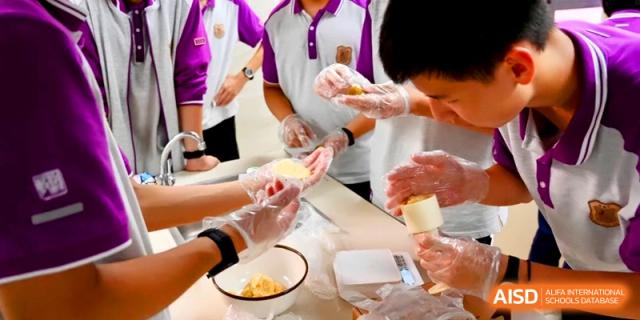 A close-up shot shows students expertly assembling round pastries during a hands-on food technology session at Xishan Senior High School.