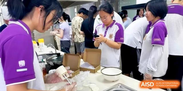 A student focuses on packaging her finished baked goods into boxes in a clean, bright kitchen at Xishan Senior High School.