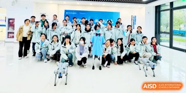 A large group of students in white jackets pose for a commemorative group photo in a lobby at Kunshan Senior High School.