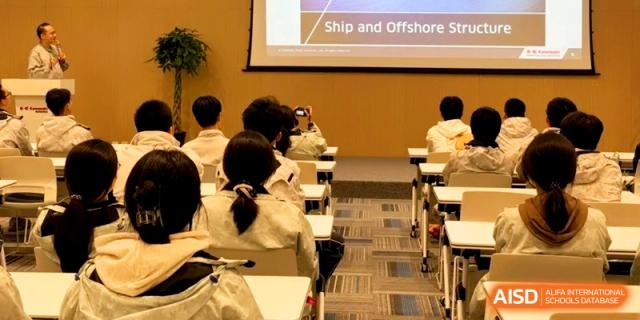 Students in an auditorium look at a presentation slide titled "Ship and Offshore Structure" at Kunshan Senior High School.