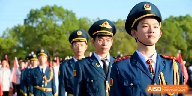 Students in formal military-style uniforms stand in formation during a ceremony at Kunshan Senior High School.