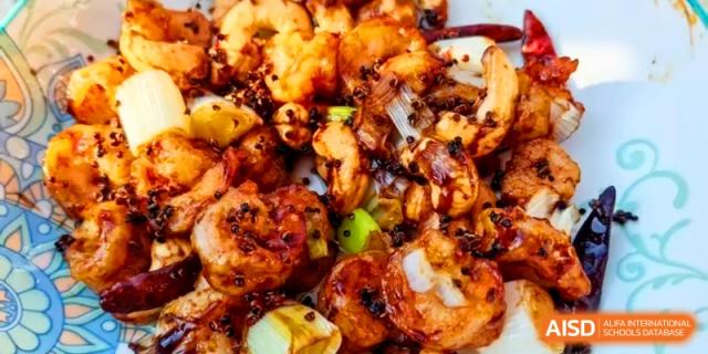 A spicy stir-fry dish featuring succulent shrimp, peppers, and traditional Chinese spices at Kunshan Senior High School.