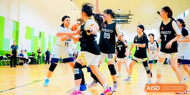 Female basketball players in action during a fast-paced game at Maple Leaf International School - Xi_an.