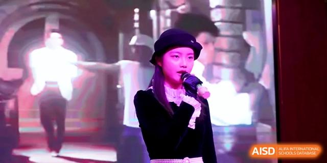 A young female student singing a solo during a school concert at Maple Leaf International School - Xi_an.