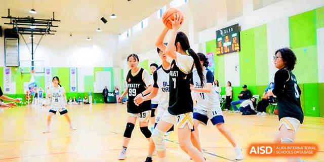 A student athlete taking a shot during a basketball competition at Maple Leaf International School - Xi_an.
