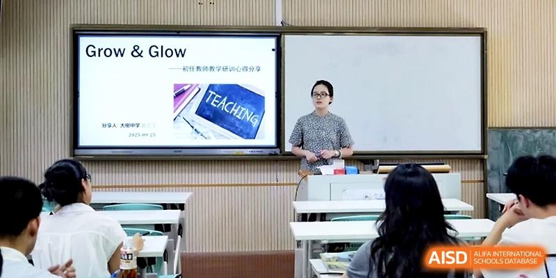 A female teacher stands by a digital screen displaying "Teaching" during a classroom lesson at Ningbo Beilun High School.