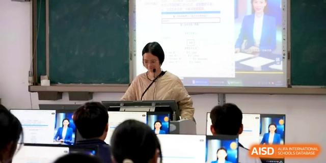 A teacher presents a lesson using a digital projector while students watch from their desks at Ningbo Beilun High School.