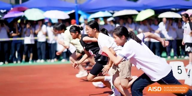 A group of female students prepares for the start of a sprint in their designated lanes at Ningbo Beilun High School.