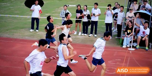 Athletes compete in a high-speed sprint during the annual school sports day festivities at Ningbo Beilun High School.