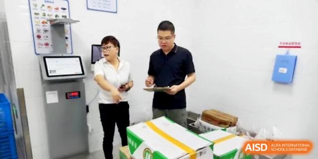 School administrators review nutrition logs and kitchen records during a routine health check at Ningbo Beilun High School.
