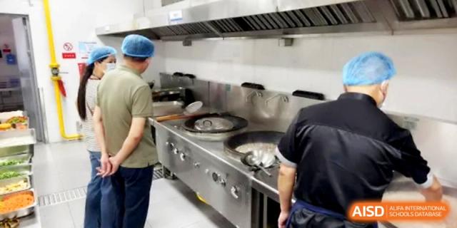 A view of the professional, clean industrial kitchen equipment used for student meals at Ningbo Beilun High School.
