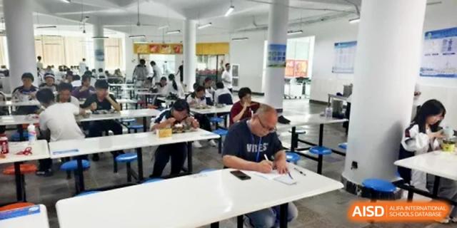 Students and staff dine in a clean, well-organized cafeteria during the school lunch break at Ningbo Beilun High School.